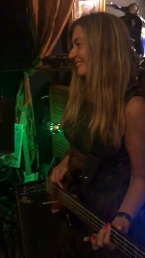 Mariana Marchesini playing bass guitar